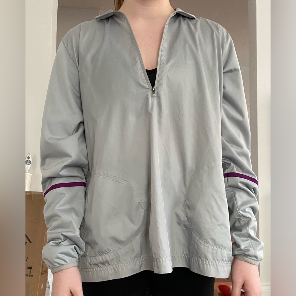 Lightweight, water resistant quarter zip with purple accent by Nike!